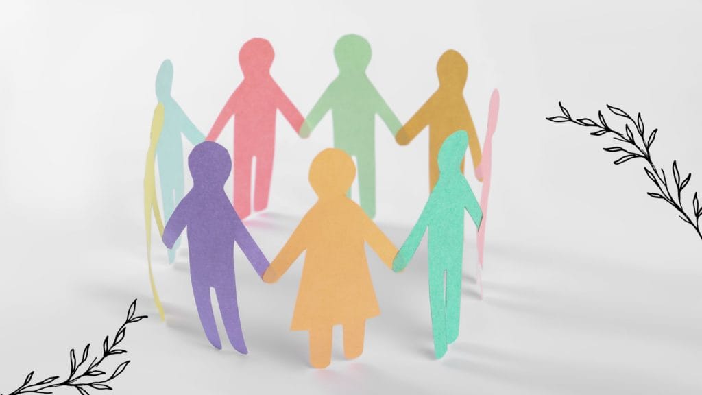 Paper cut out people holding hands and standing in a circle