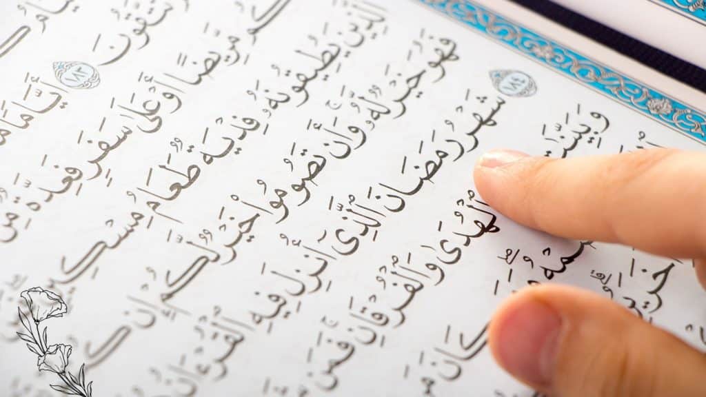 Quran with finger on it, as if reading