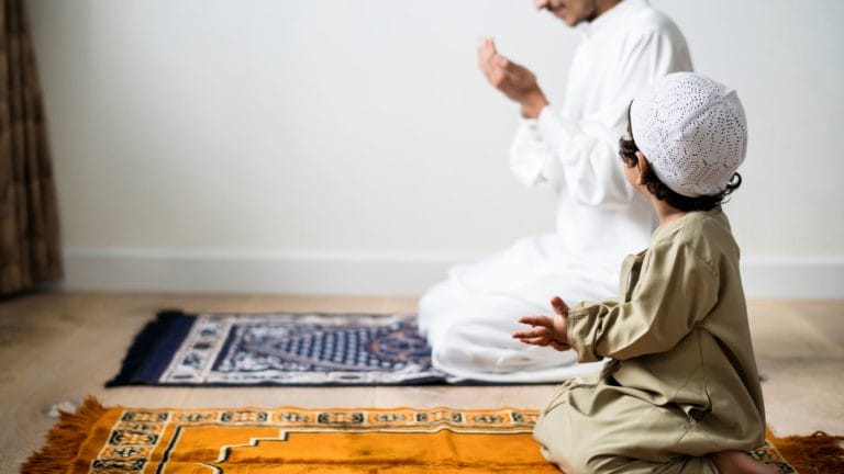 child praying with man, watching him