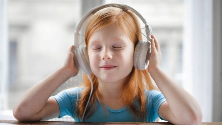 little girl listening to headphones