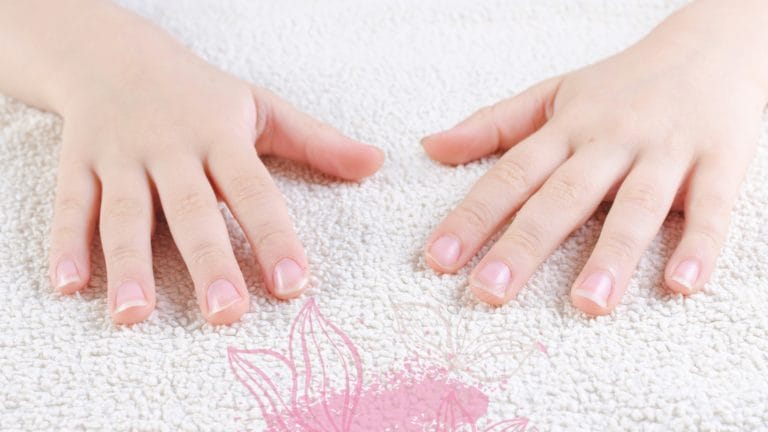 a child'd hands with nails that need to be cut