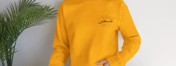 Palestine crewneck gold worn by a woman