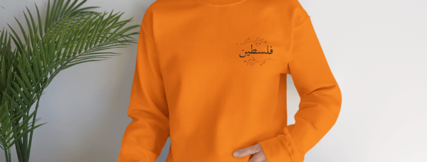 Palestine crewneck safety orange worn by a woman