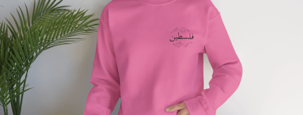 Palestine crewneck safety pink worn by a woman